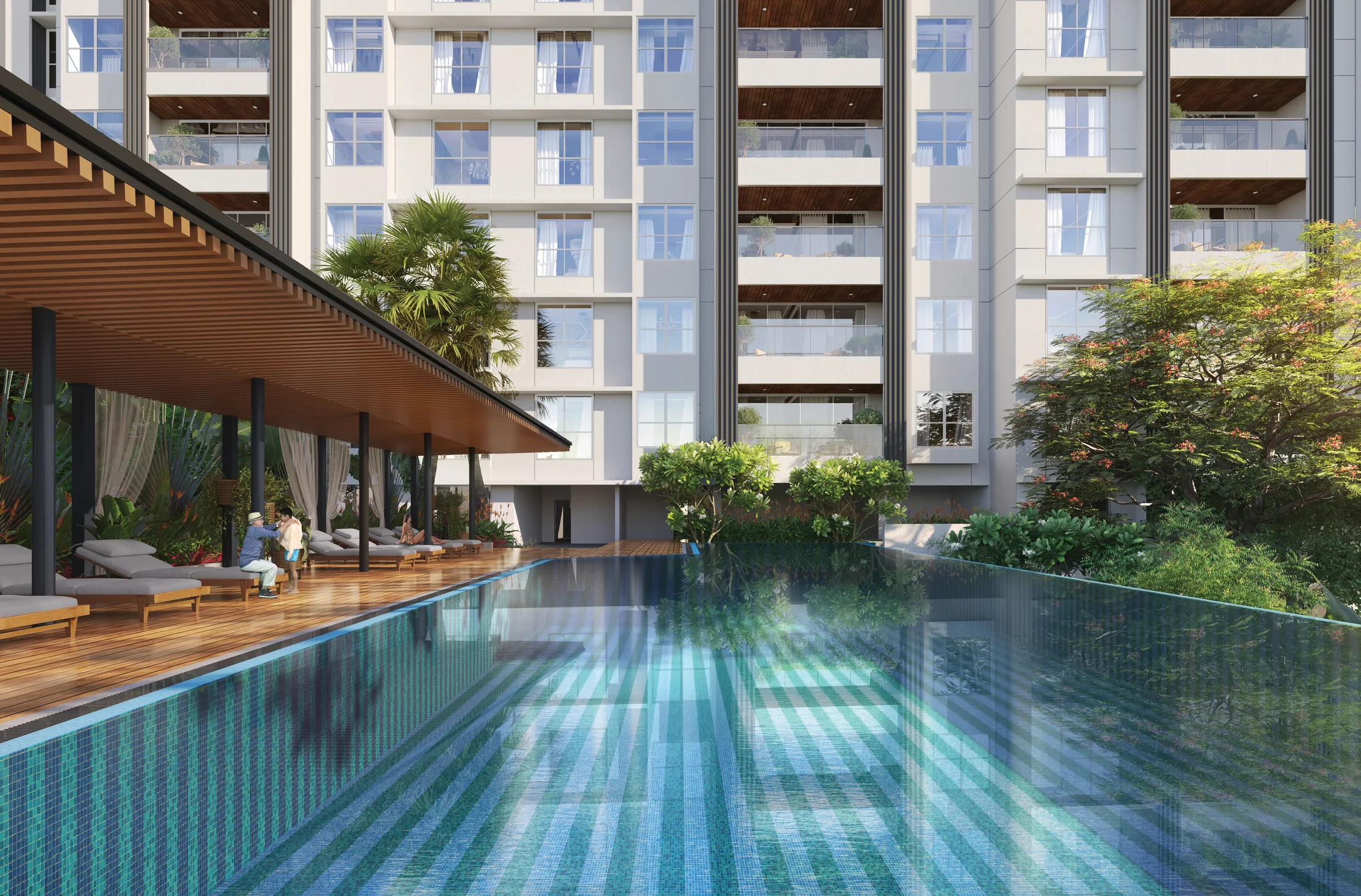 Swimming pool with a shaded deck below the towers at The Reserve, Mundhwa