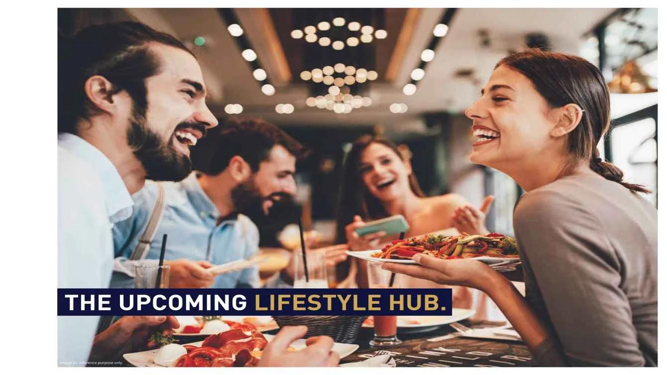Group of friends laughing over a meal at Bizzbay Commercial, Tathawade