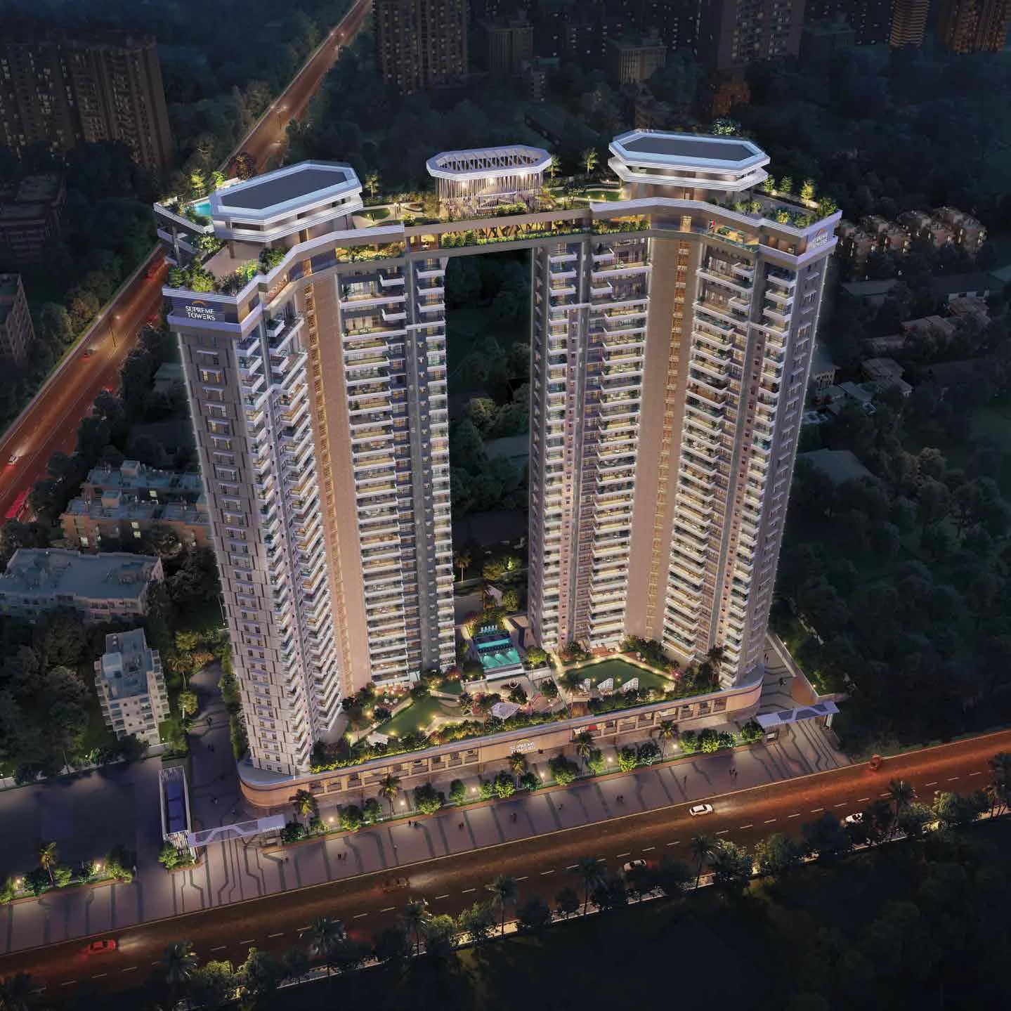 Aerial night view of the twin towers and the Cloud Walk sky bridge at Supreme Towers, Mundhwa