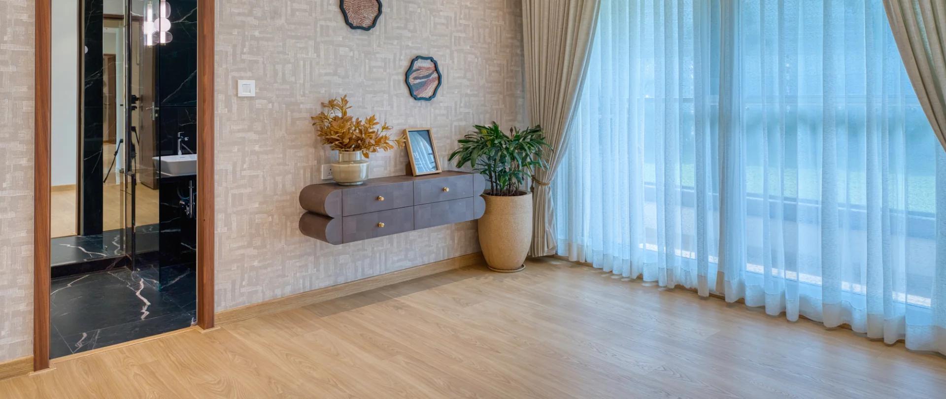 Sample flat bedroom with wooden flooring and an attached bathroom at Palladio Presidential Towers, Hadapsar