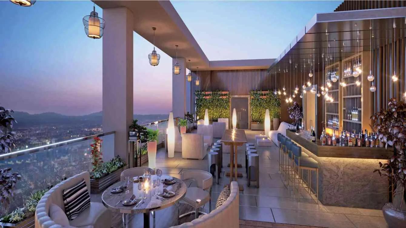 Rooftop bar and dining terrace at dusk at Tej One, Baner