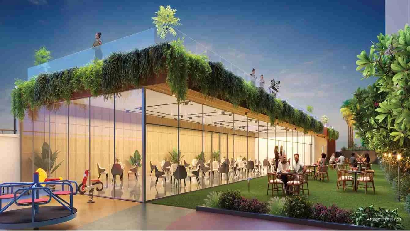 Glass-fronted rooftop cafe with green roof and play equipment at Tej One, Baner
