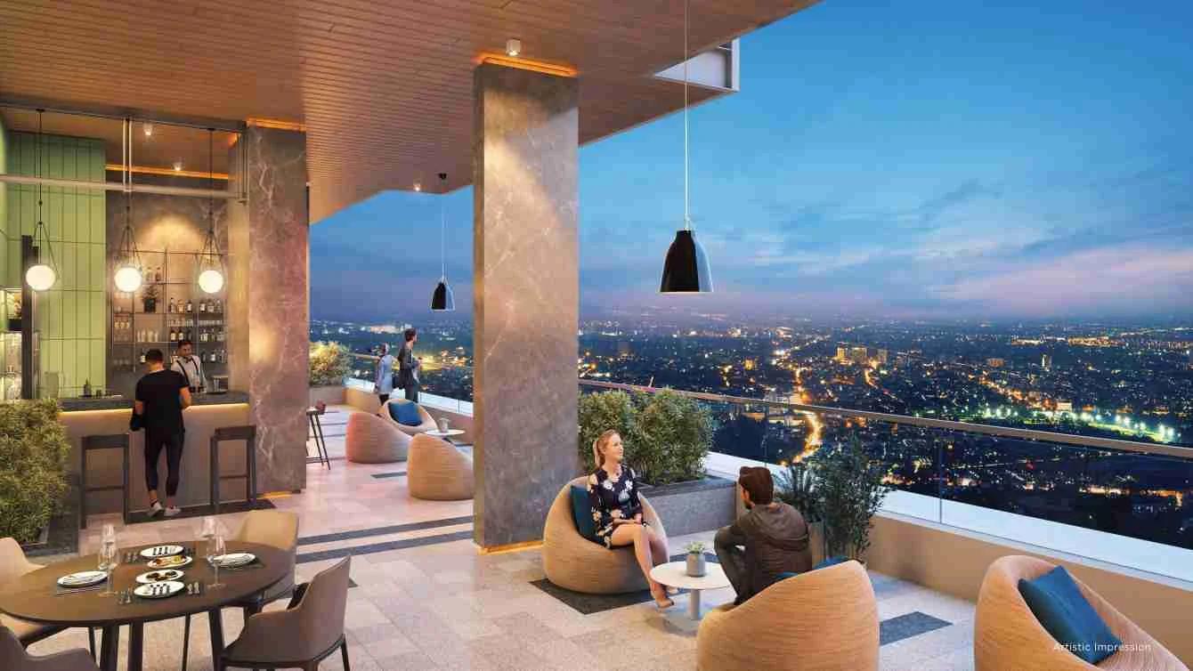 Terrace bar and seating overlooking city lights at dusk at Tej One, Baner