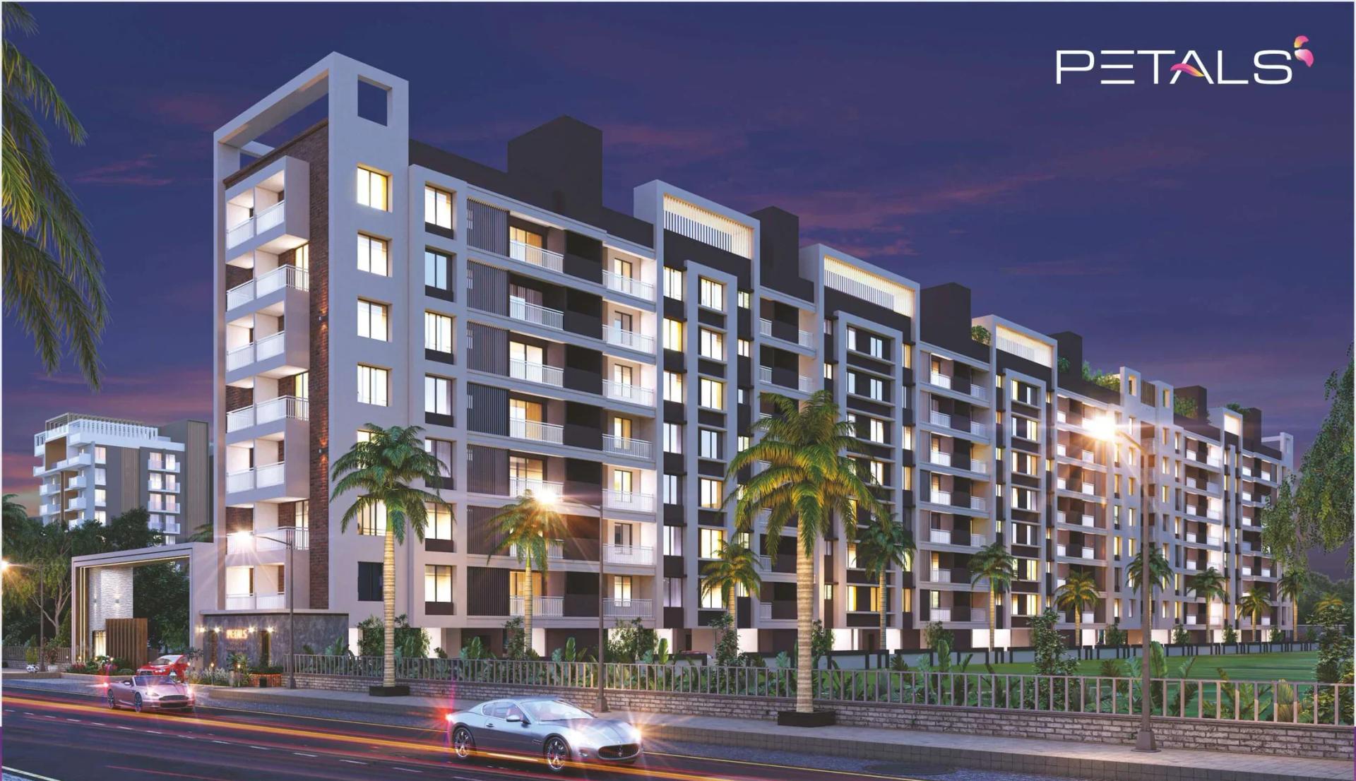 Residential wings lit up at dusk along the road at Petals, Tathawade
