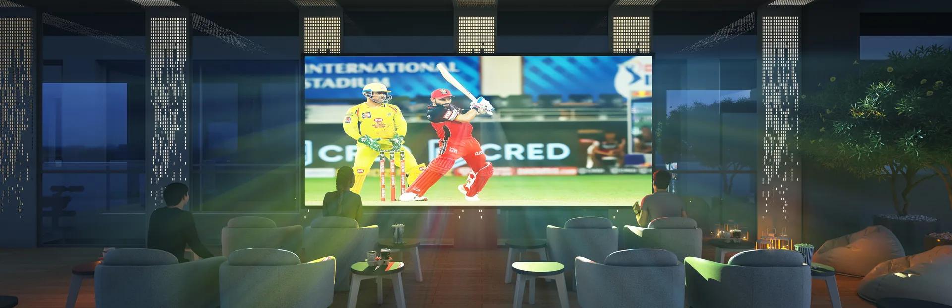 Outdoor movie projection lounge with a large screen at Dream Delmont, Bavdhan